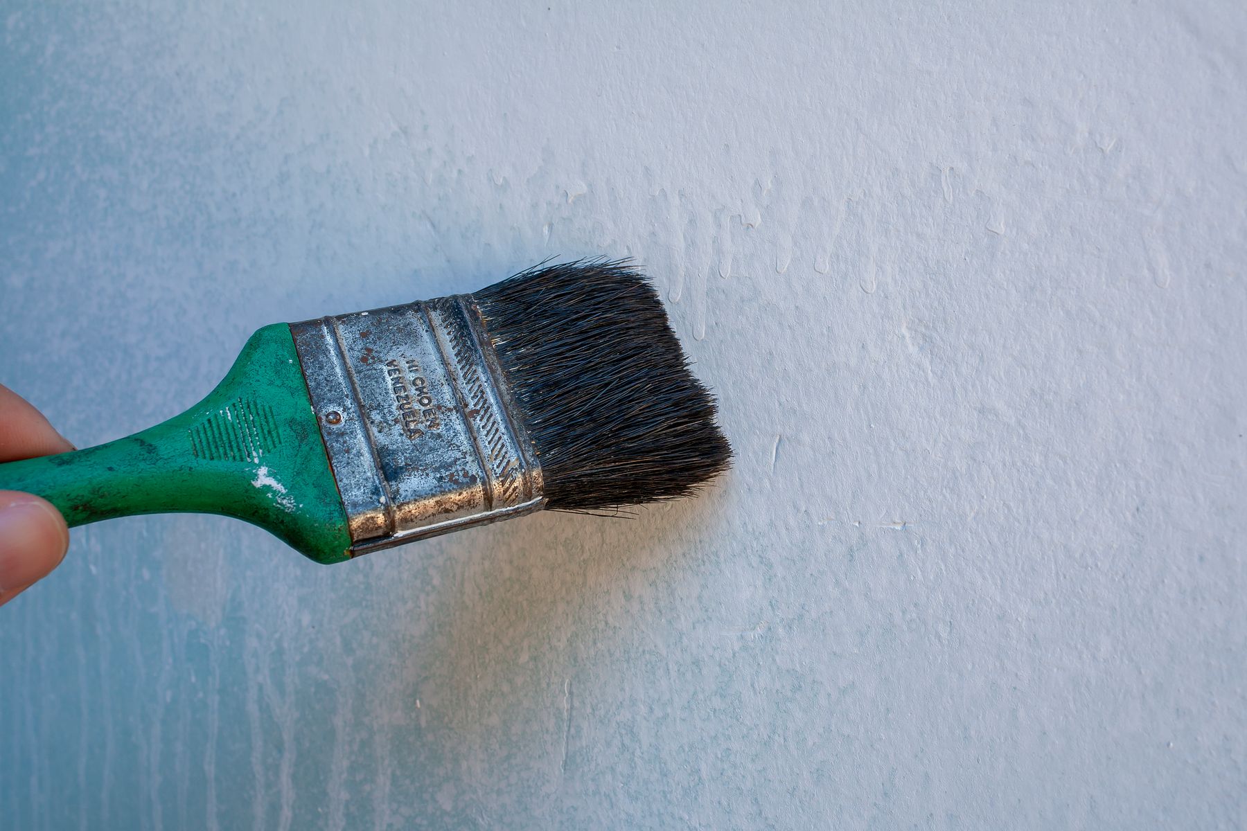 Painter applying a fresh coat to an interior wall