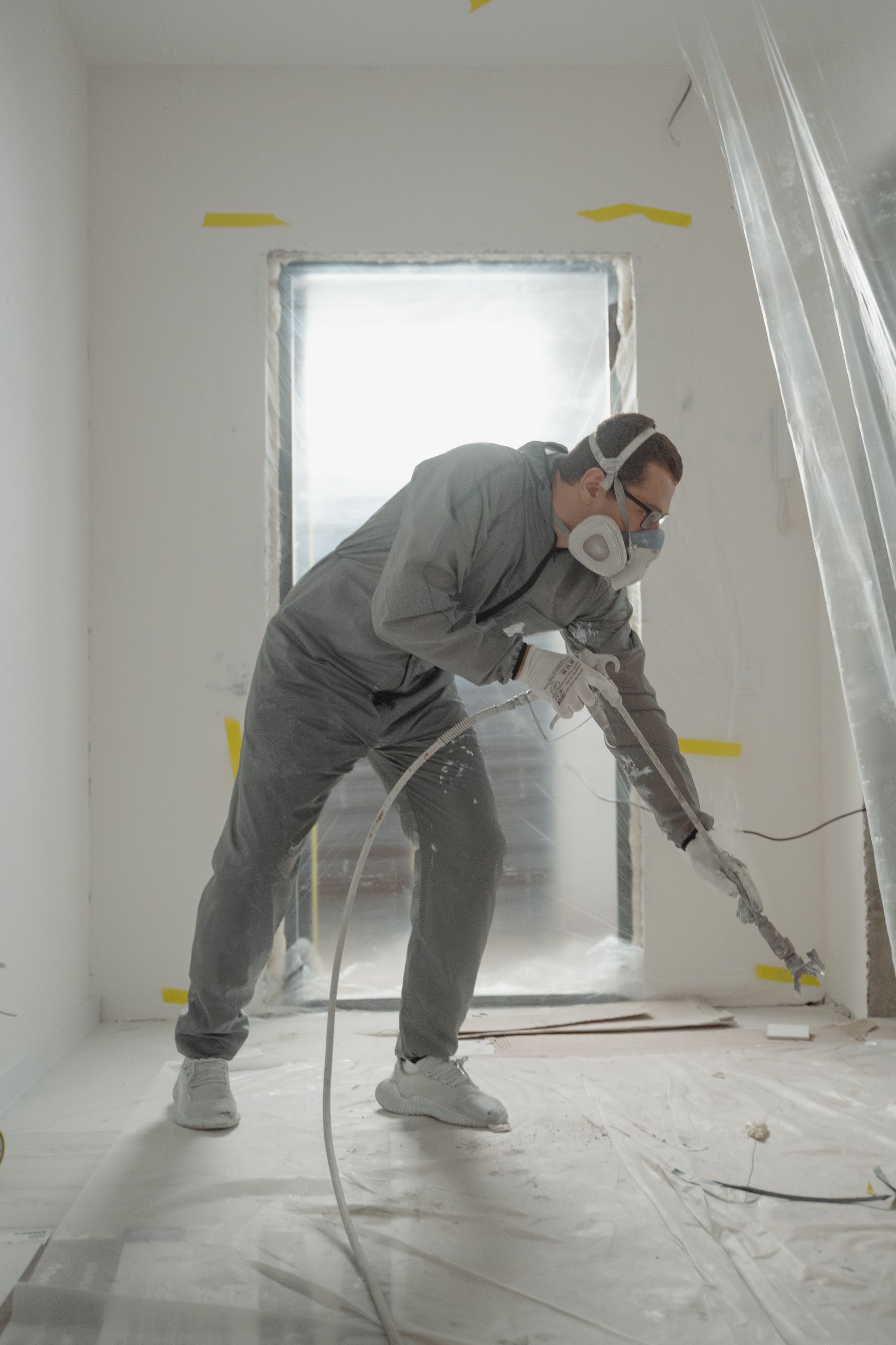 Spray painter working in a protected interior